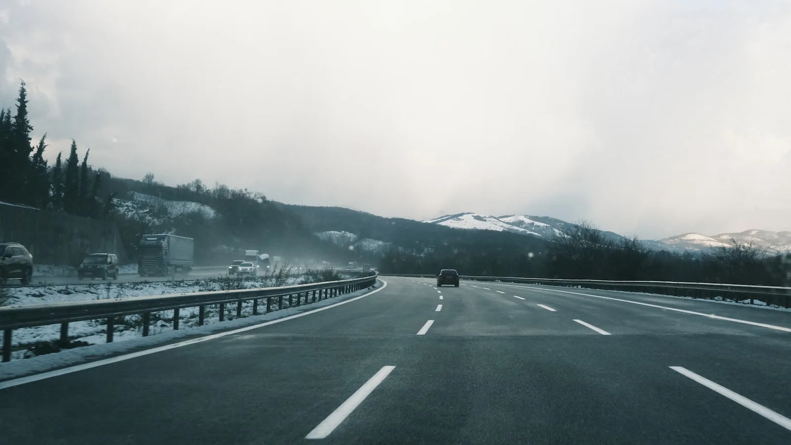 A car driving down a road in the snow